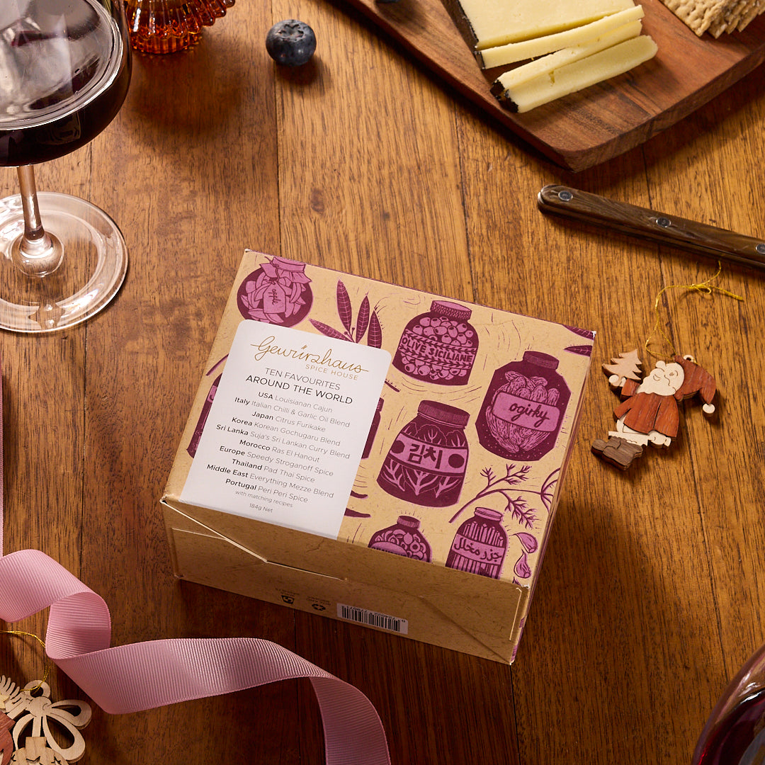 Gewürzhaus Ten Favourites - Around the World Gift Box on a table with christmas decorations 