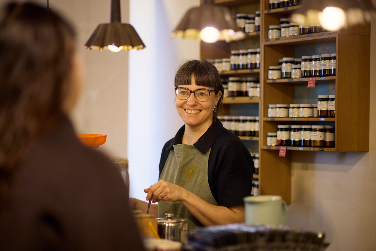 Spice Merchant serving a customer in store.