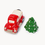 A ceramic Christmas-themed set featuring a red pickup truck and a green Christmas tree, both with white accents, photographed on a clean white background.